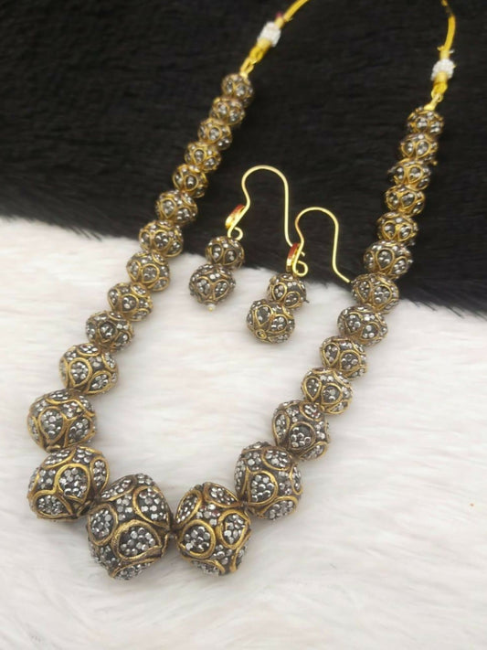 Noor Bilal mala set with gold-toned bead detailing, sparkling stone embellishments, and matching earrings.