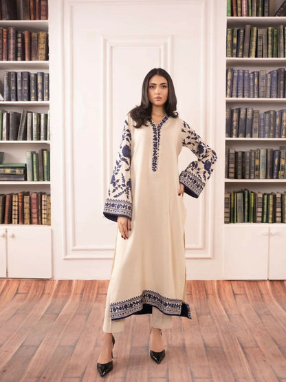 Stitched 2-piece suit featuring embroidered cotton tunic with floral detailing and matching cotton trousers with refined border.