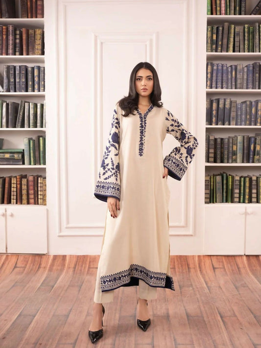 Stitched 2-piece suit featuring embroidered cotton tunic with floral detailing and matching cotton trousers with refined border.