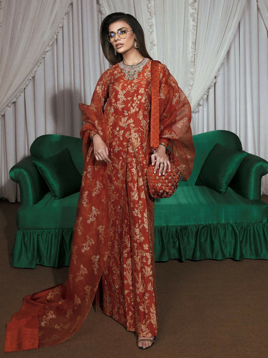 Rust raw silk stitched 2-piece suit Flamme by HussainRehar featuring a hand-worked neckline with pink, green, ice blue, and gold bugle beads, gold, teal, and green sequins, nakshi, mukaish, and dabka, with scattered hand-worked details and a central box pleat, paired with a block-printed organza dupatta with satin pallu, ideal for festive occasions