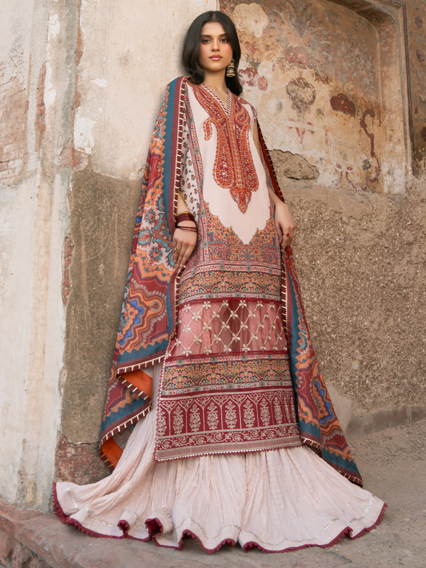 Digital printed 3-piece unstitched suit with embroidered neck and lace detailing, paired with chiffon dupatta and cotton trouser.