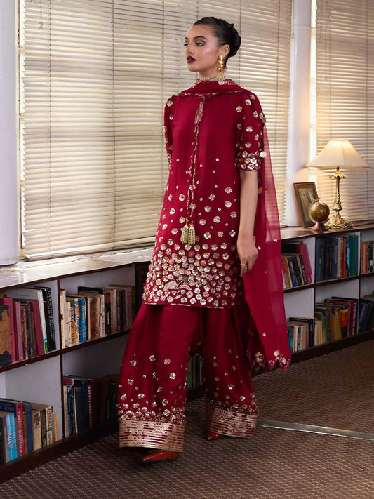 Hussain Rehar hot pink 3-piece raw silk short shirt with golden mukesh and dabka hand embellishments, raw silk shalwar with chanderi border, and chiffon dupatta with floral hand embellishments