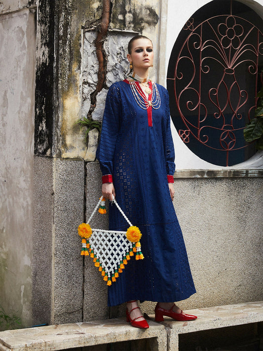Woman wearing cotton long straight shirt with shiffli embroidery, slide slits, and red detailing on sleeves and neckline, 1-piece unstitched shirt.