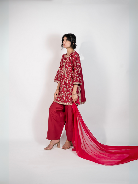 Trends Forever Karam Collection red lawn stitched 2-piece suit featuring embroidered shirt with plain trouser, displayed in a graceful and modern setting.