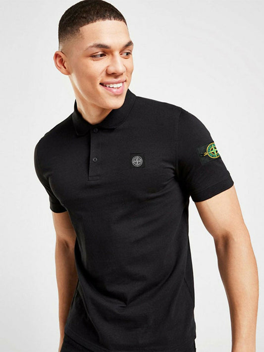 A man wearing a slim-fit black pique polo with a Stone Island badge on the left arm and an embroidered logo on the chest.