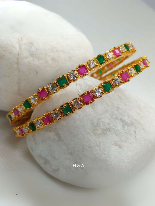 H&A Jewellery one carat traditional bangles adorned with white, green, and pink semi-precious stones.