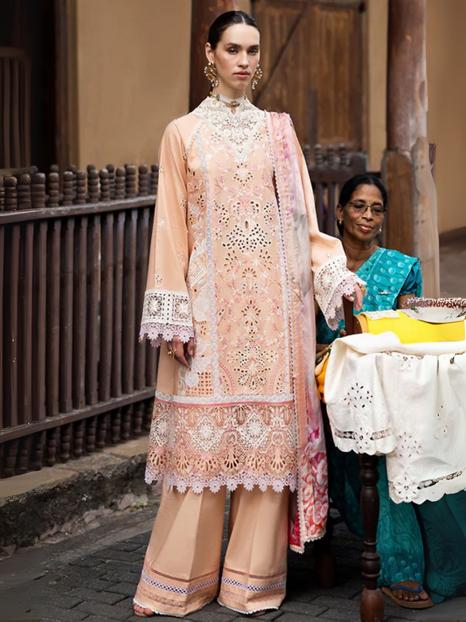 Mushq unstitched 3-piece suit with chikan embroidered lawn panels, appliqué details, laser cut organza borders, crochet laces, digital printed silk dupatta, and dyed cotton trousers.