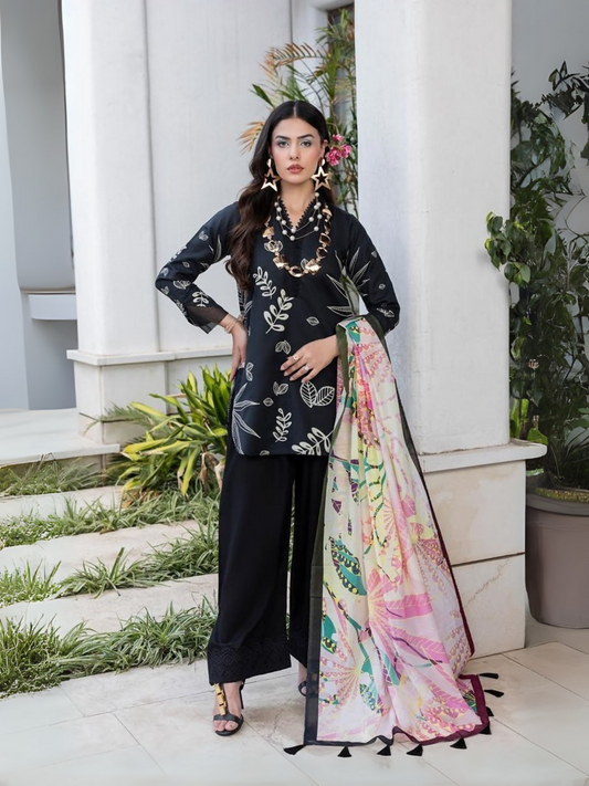 Unstitched 3-piece suit with leafy printed black lawn shirt, printed dobby voil dupatta with tassels, and dyed cotton trouser, perfect for summer tailoring.