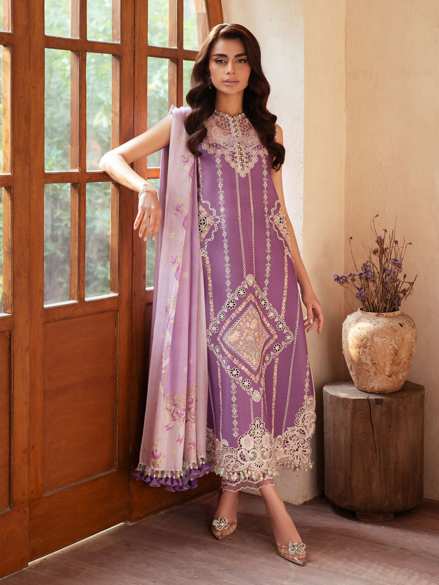 Embroidered lawn suit featuring organza neck and daman motifs, printed silk dupatta, and dyed cotton trouser.