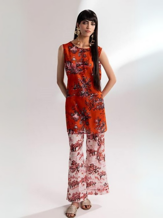 Woman wearing a vibrant orange floral sleeveless shirt with matching printed trousers from Parizad’s premium lawn collection.