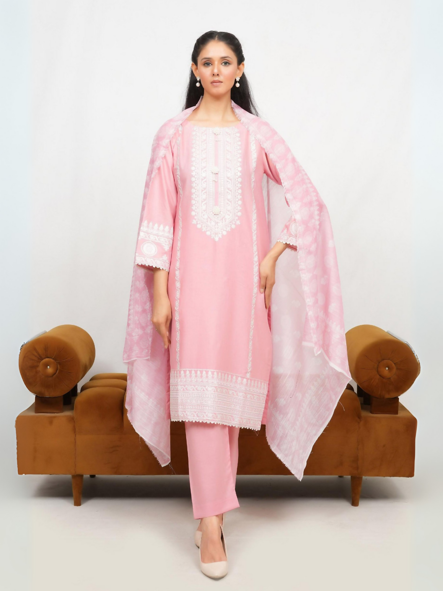 Woman wearing stitched 3-piece suit with exquisite sequence embroidery on straight-cut shirt, finely detailed craftsmanship, digitally printed dupatta, and matching wide-leg trouser.