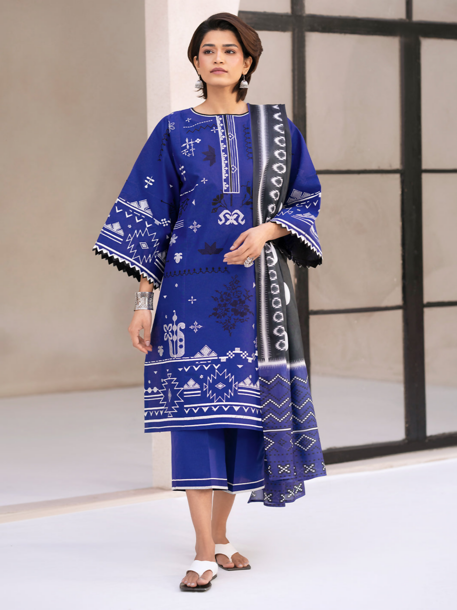 Elegant embroidered lawn shirt with coordinated front panels and sleeves, paired with a digitally printed silk dupatta and plain dyed cotton trouser.
