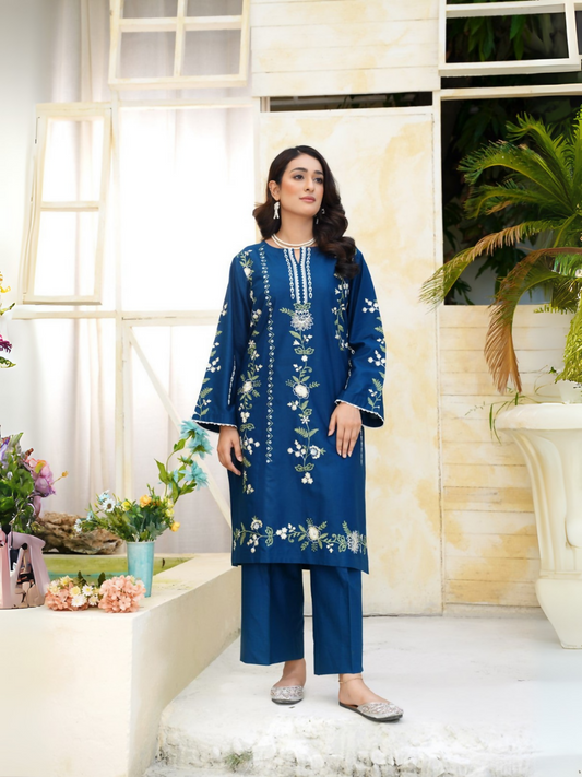 Girl wearing Trends Forever deep blue lawn cotton embroidered kurta with ivory and green floral motifs and matching straight trouser; stitched 2-piece suit.