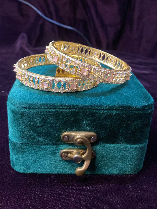 Noor Bilal Bangles set with intricate designs featuring pink stones at the center, elegant jewellery for women.