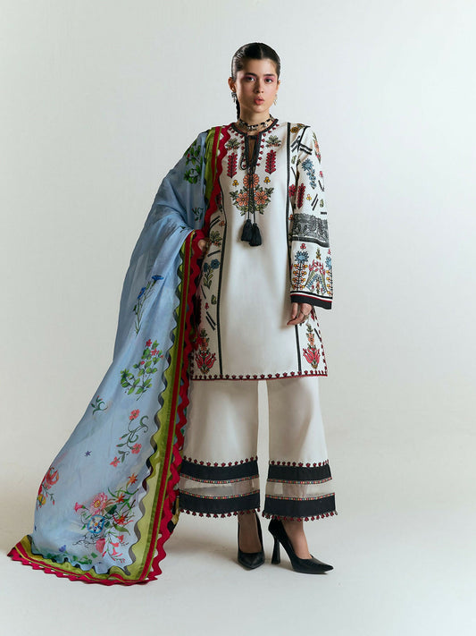 Ivory cotton shirt with multicolor embroidery on front, sleeves, and borders, matching embroidered culottes with black and red hem accents, and digitally printed silk dupatta with floral motifs and magenta-green scalloped border.