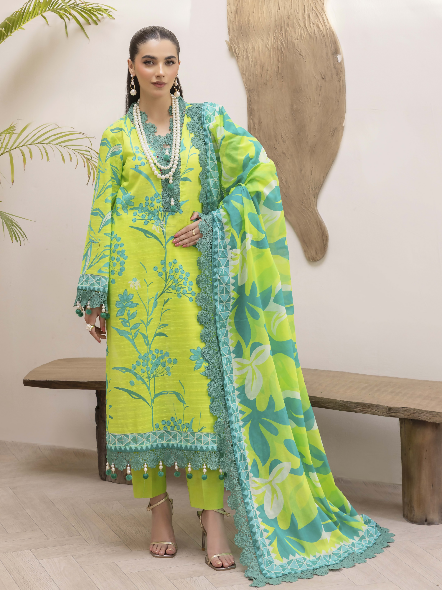 Girl standing wearing an unstitched 3-piece suit with premium digital printed slub lawn shirt, digital printed pure voile dupatta, and dyed cotton trouser, designed for stylish summer comfort.