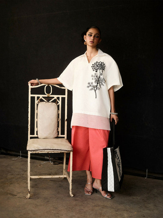 Girl wearing cotton ivory V-neck collared shirt with organza hem and coral culottes, stitched 2-piece suit