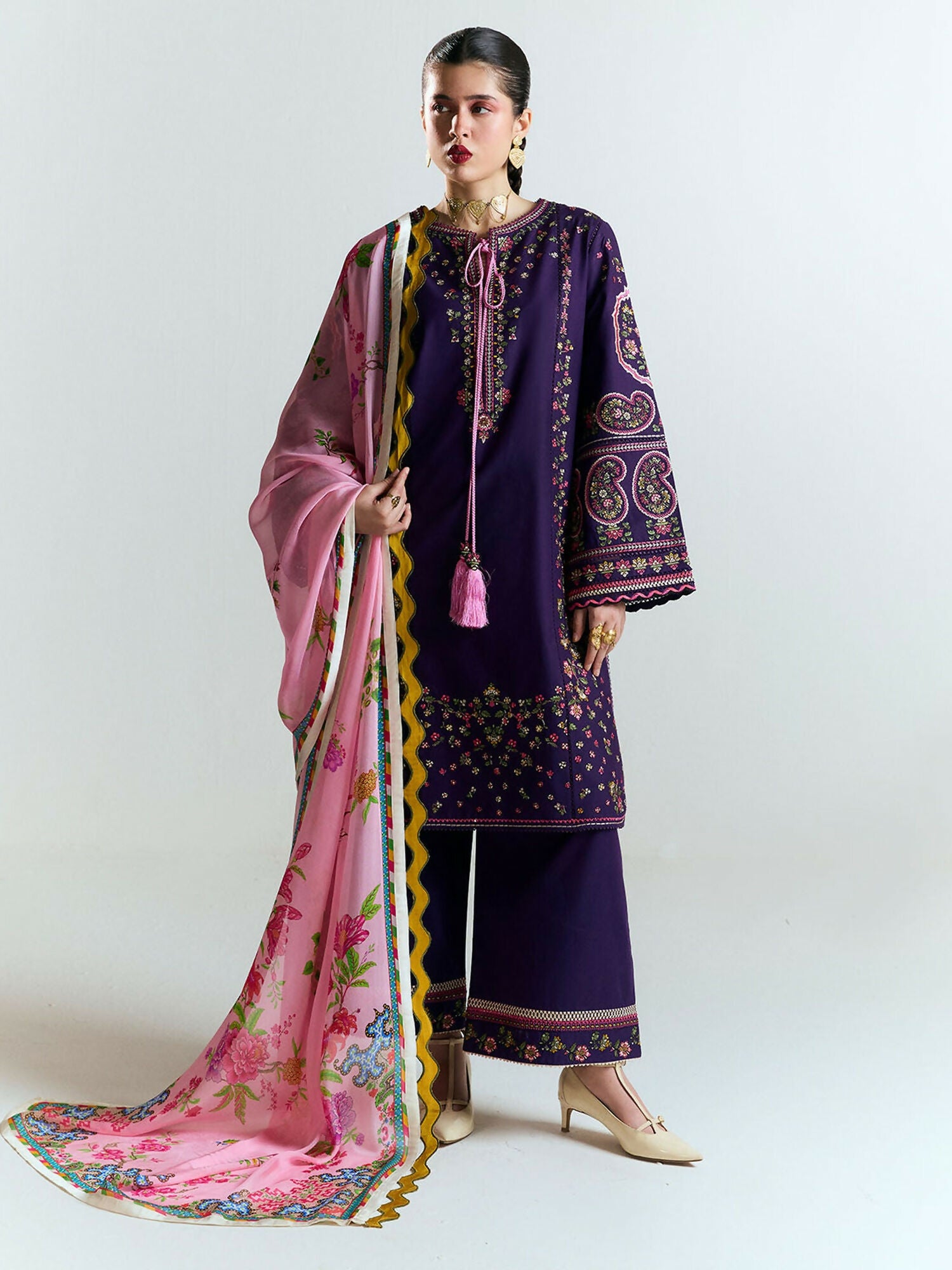 Purple cotton shirt with multicolor floral embroidery and mustard-ivory zigzag borders, matching embroidered culottes, and blush pink digitally printed silk dupatta with bold yellow zigzag border and large floral motifs.