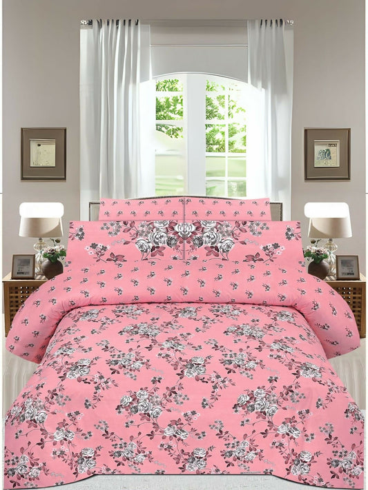 A pink king size bedsheet with soft floral print, paired with matching pillow covers on a neatly arranged bed.