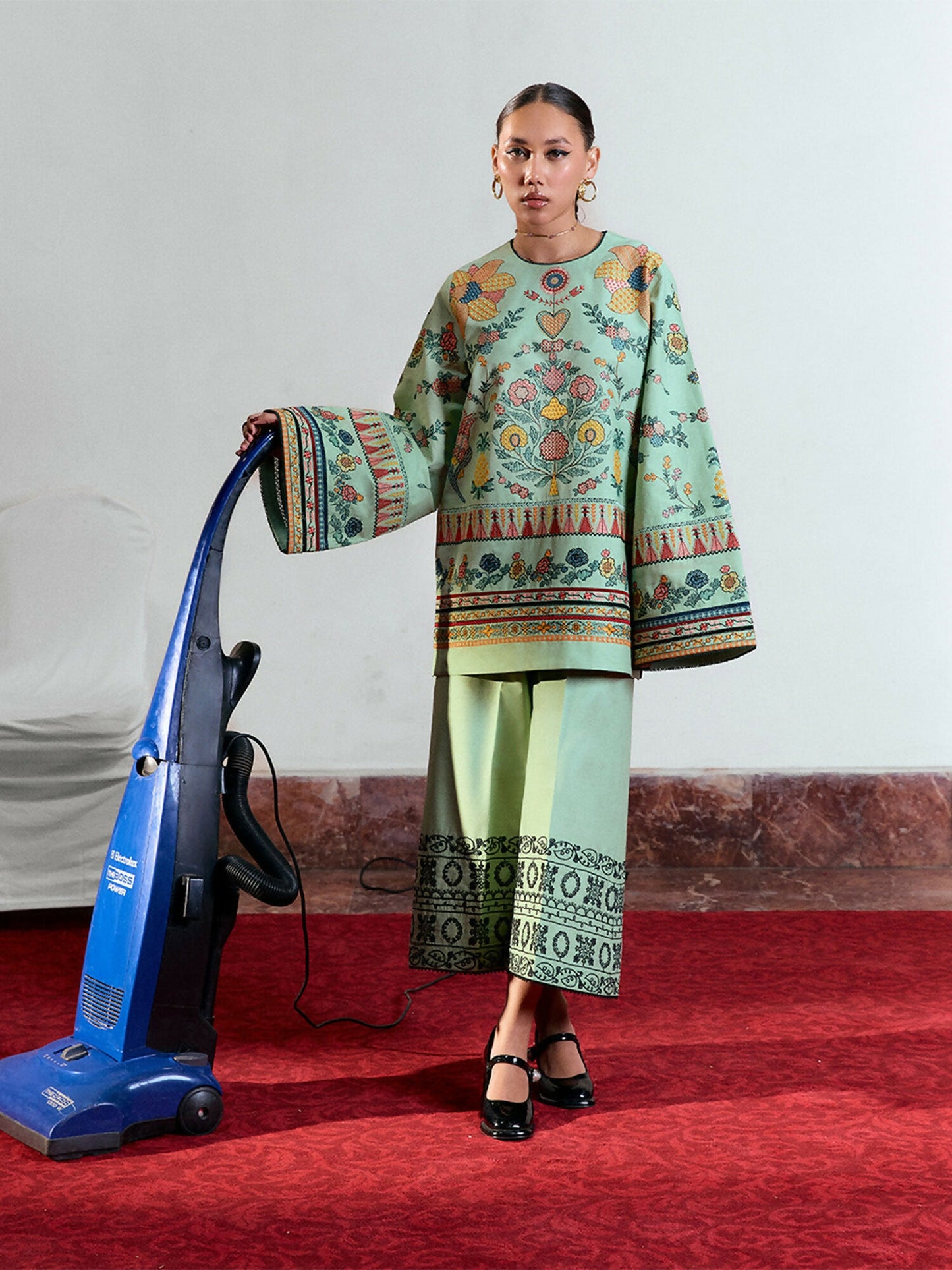 Light green cotton short shirt with multicolor floral embroidery, bell sleeves with matching embroidery, and light green cotton culottes with monochrome dori embroidery.