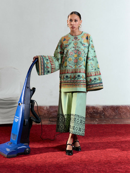 Light green cotton short shirt with multicolor floral embroidery, bell sleeves with matching embroidery, and light green cotton culottes with monochrome dori embroidery.