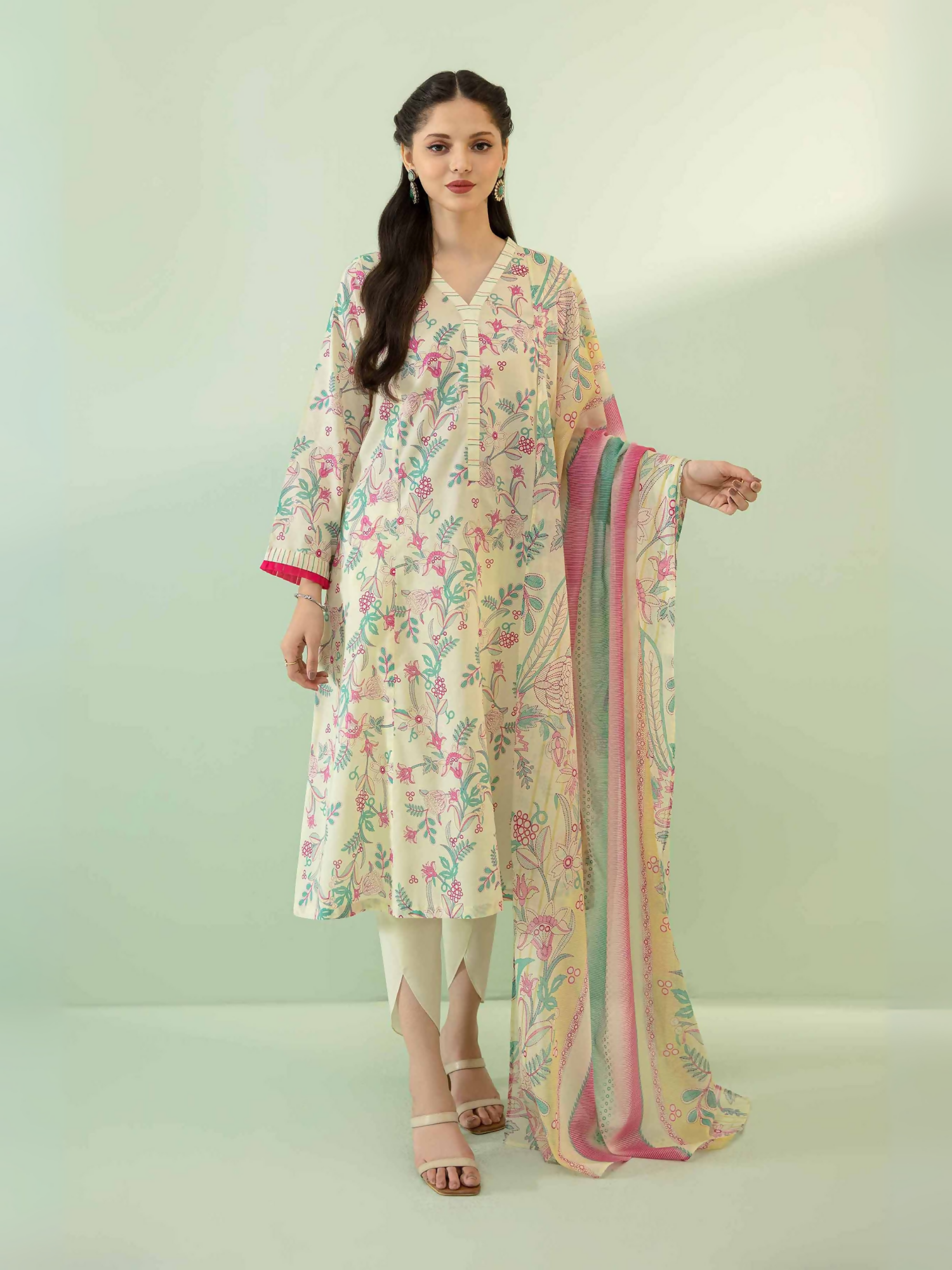 Nishat unstitched 3-piece lawn suit in pink and off-white with embroidery-style floral patterns, voile dupatta, and cambric trouser.