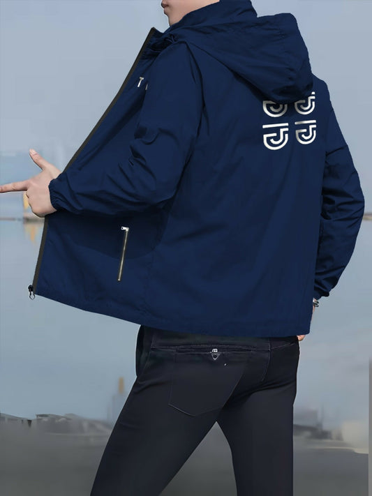 A man wearing a navy blue hooded windbreaker jacket with white geometric logo prints on the upper back and zippered side pockets.