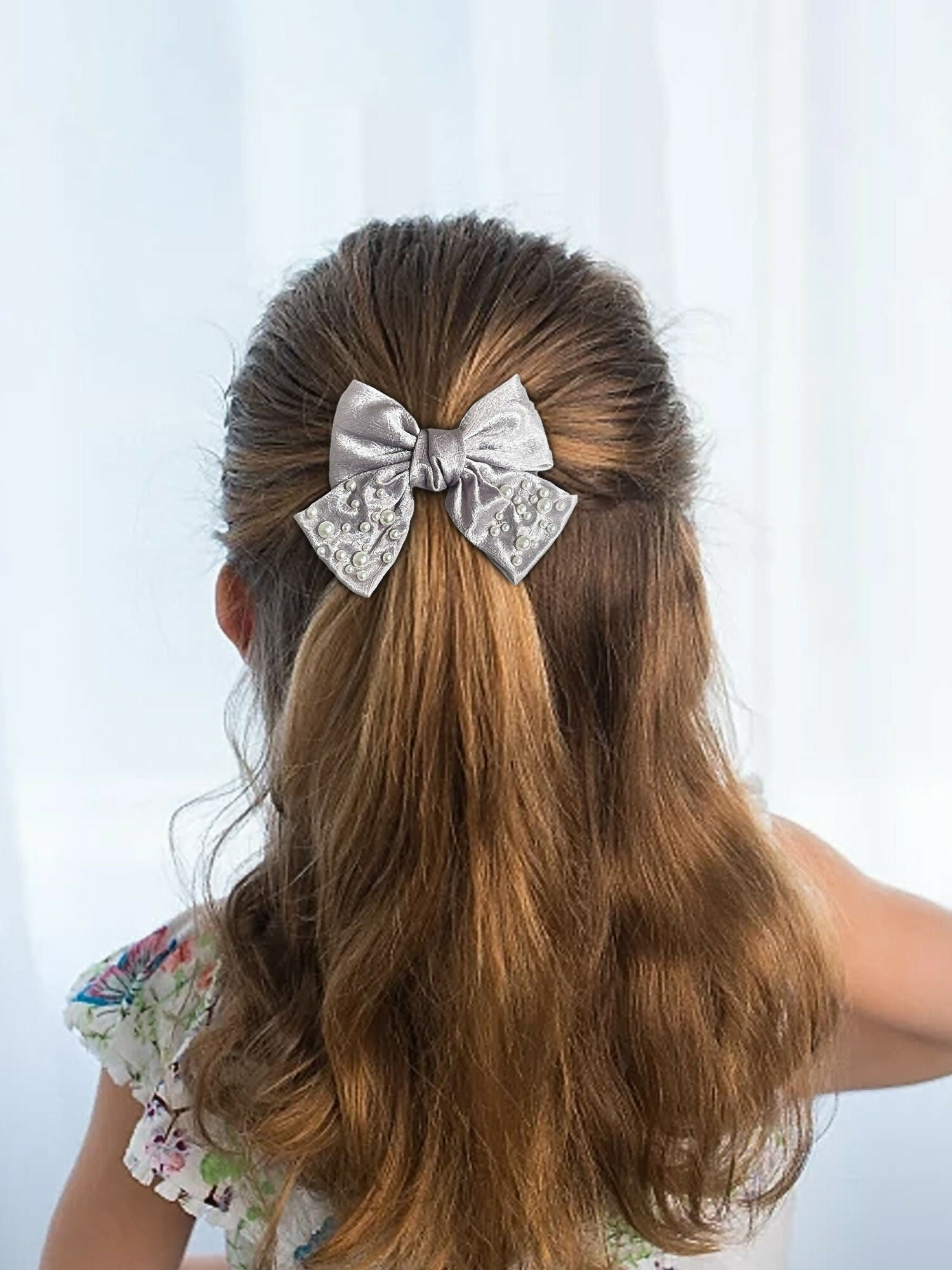 Girl wearing Glitter Jewellery embellished hair bow with delicate pearl details