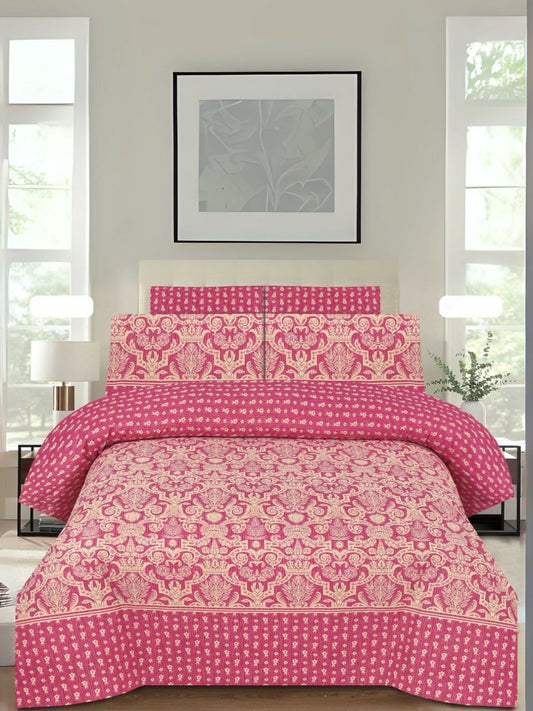 A pink bedsheet with golden printed design and matching pillow covers, spread neatly on a bed.