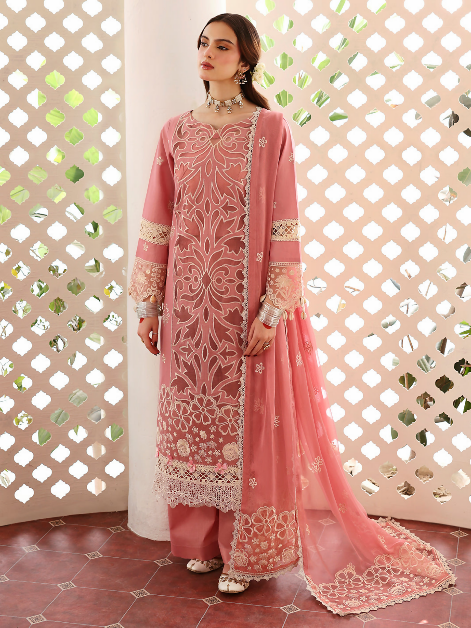 Unstitched 3-piece embroidered lawn suit with laser-embroidered front, embroidered back and sleeves, decorative embroidered borders, embroidered chiffon dupatta, and dyed trouser.