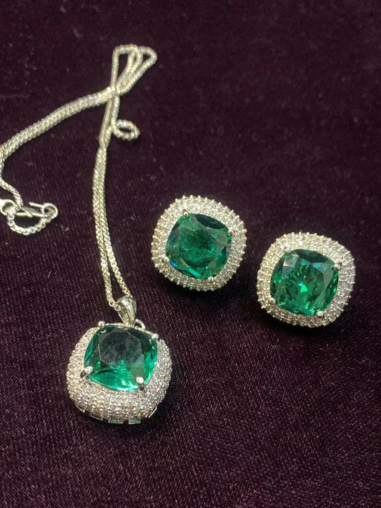 Noor Bilal – green zircon stone pendant set with matching earrings and shimmering stone detailing.