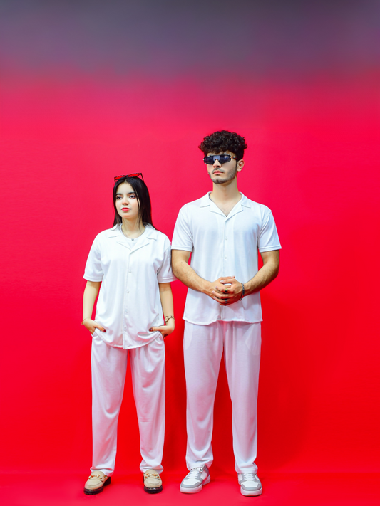 Unisex French pique coord set featuring a collared short-sleeve shirt and matching drawstring pants, styled for casual comfort and modern appeal.