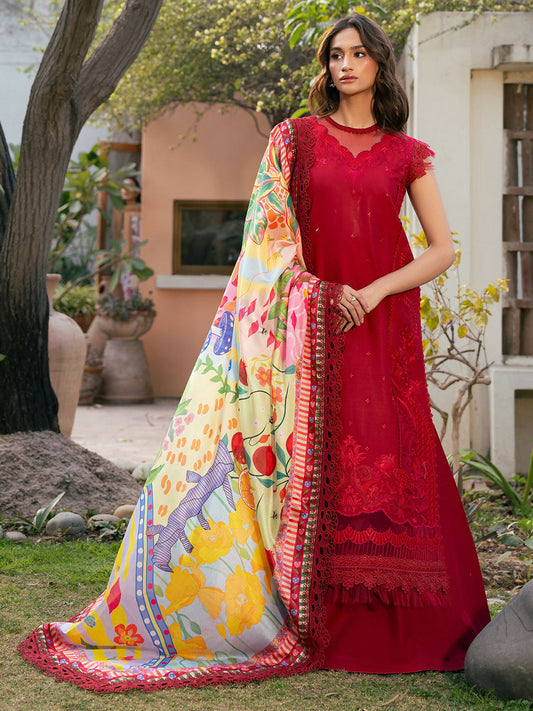 Woman wearing a deep red unstitched embroidered lawn outfit with intricate detailing on the front and sleeves, paired with a vibrant multicolor printed silk dupatta and solid red trouser, styled in an outdoor setting.