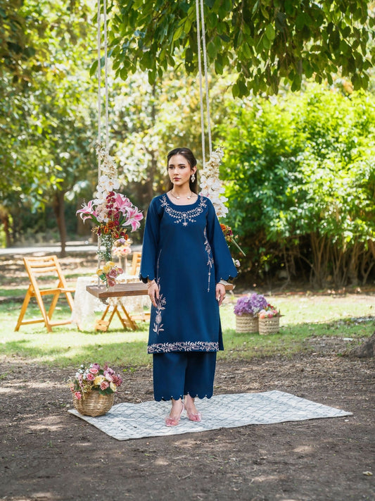 Navy blue stitched two-piece suit with embroidered front and sleeves, scallop detailing on sleeves, paired with straight trousers with parallel scallop design by Sehrish Kanwal.