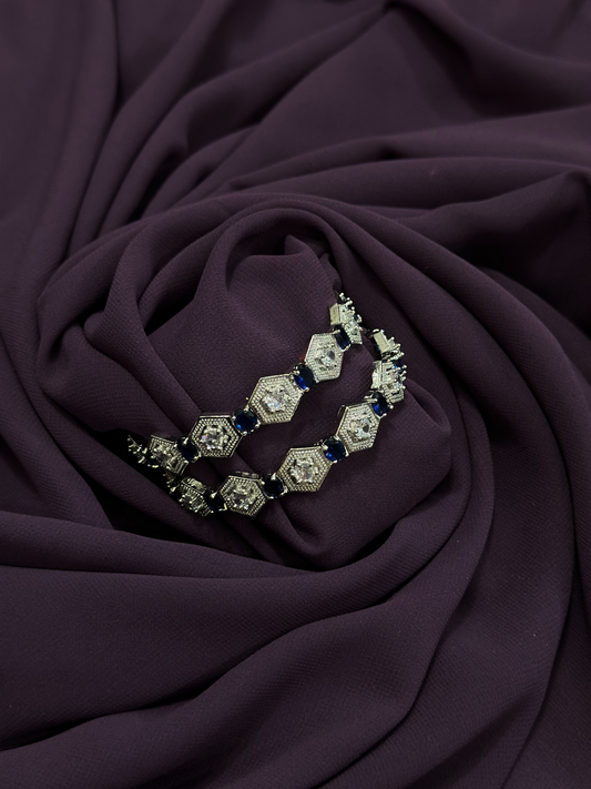 Pair of 2.25-inch bangles with alternating navy blue and clear imitation crystals set in a hexagonal metallic design – from Glitter Jewellery.