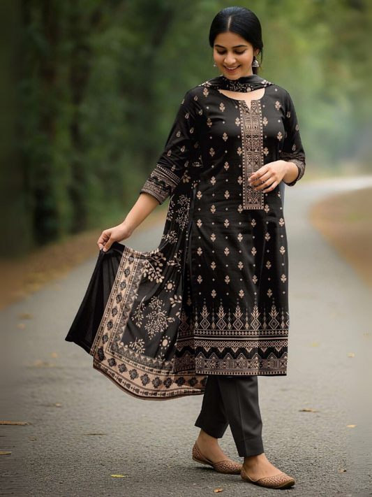 Woman in black unstitched 3-piece suit featuring digital printed lawn shirt with subtle ethnic patterns, printed voile dupatta, and plain dyed trouser