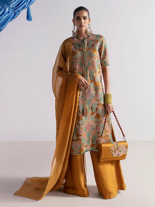 Hussain Rehar stitched 3-piece suit featuring a mustard organza embellished shirt with sequins, naqshi, and cutdana, paired with raw silk palazzo pants, organza dupatta, and Korean silk inner.