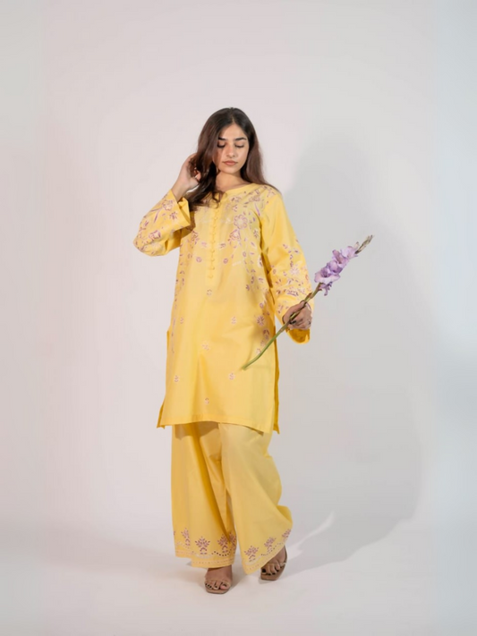 Trends Forever Karam Collection yellow lawn stitched 2-piece suit with embroidered shirt and embroidered trouser, displayed in a bright and elegant setting.