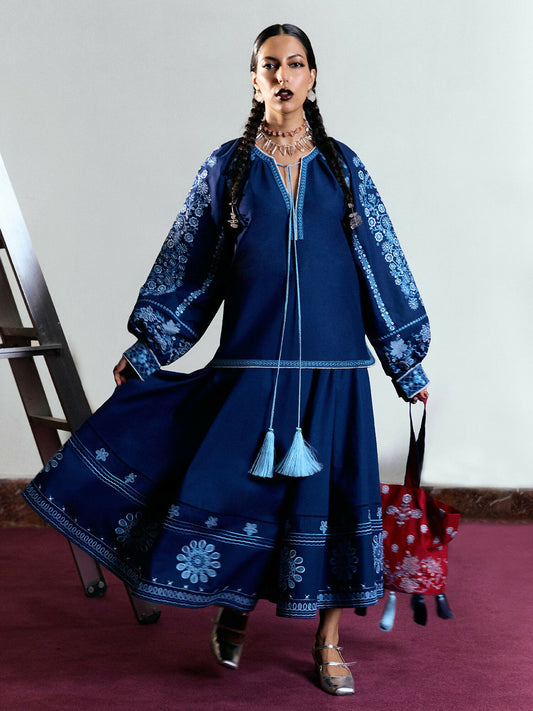 Navy blue cotton short shirt with monochrome traditional embroidery, boring, and tassels, balloon sleeves, and matching embroidered cotton skirt.
